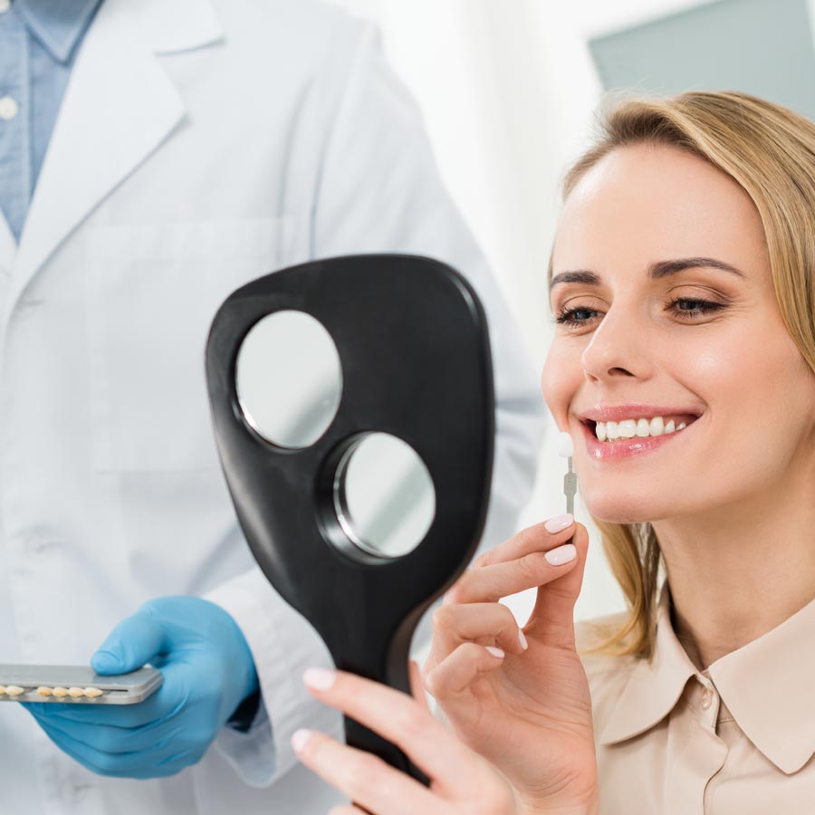 Dentist showing patient a dental mirror