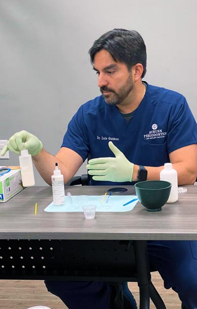 Person preparing medical supplies at a table