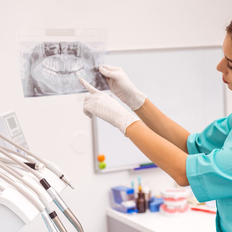 Dentist examining dental X-ray