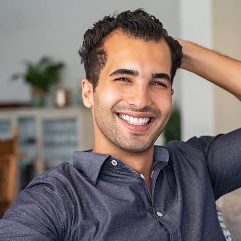 Cheerful individual indoors with plants