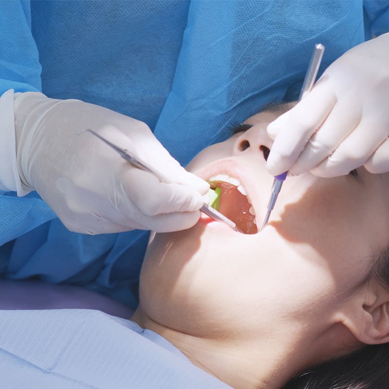 Dentist examining patient's teeth